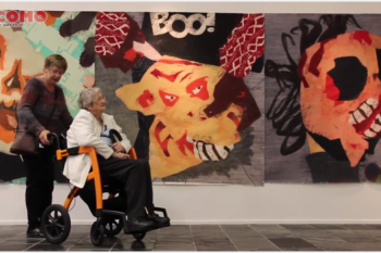 Woman walking with an orange Rollz Motion rollator