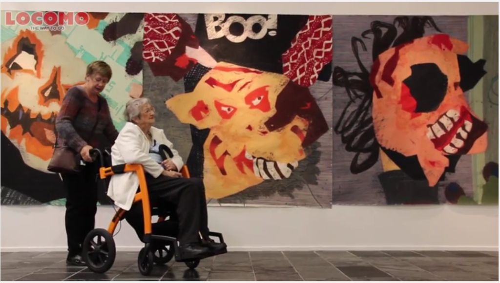 Woman walking with an orange Rollz Motion rollator