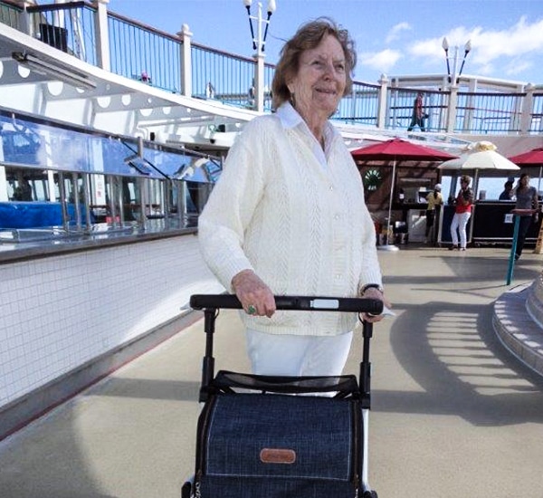 Lady talking a Rollz Flex stable rollator on a cruise ship