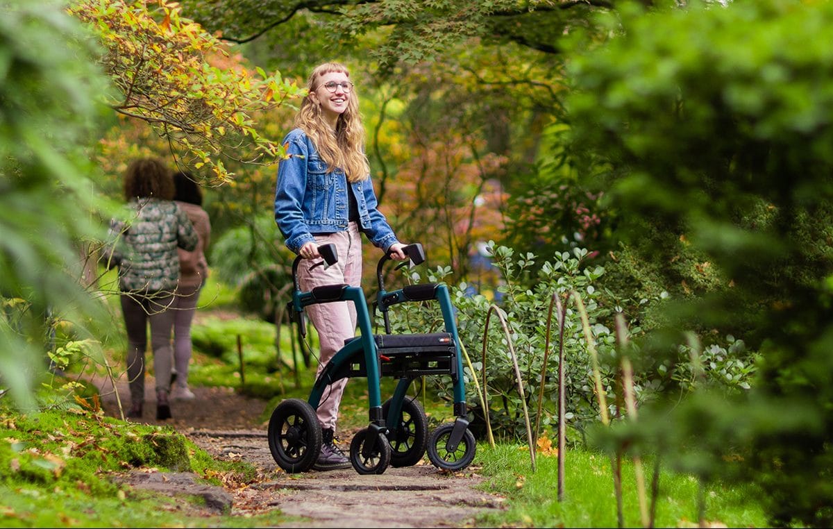 Young girl visiting a museum with a rollator with air tyres