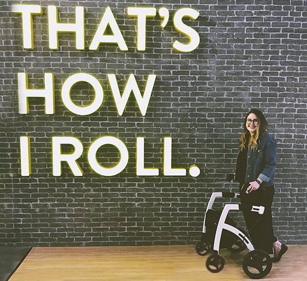 Disabled girl using a Rollz Motion rollator and wheelchair in one at the mall