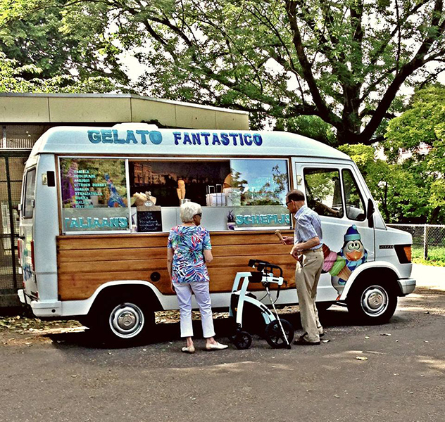 A man buying icecream while in holiday with his stable rollator