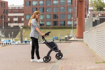 Woman showing how to go up sidewalks with rollators