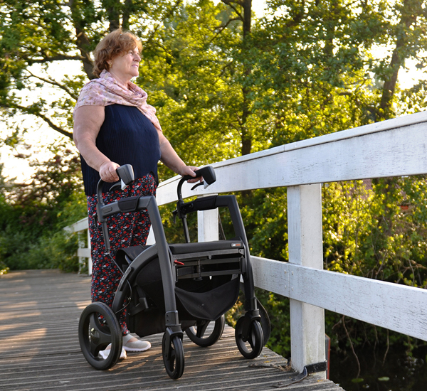 Woman walking with a Rollz Motion Rhythm rollator for people with Parkinson's