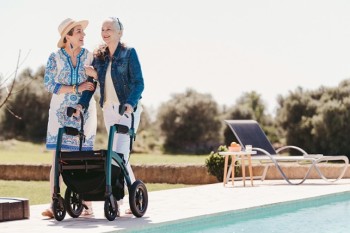 Woman walking with a Rollz Motion Performance rollator walker near a swimming pool