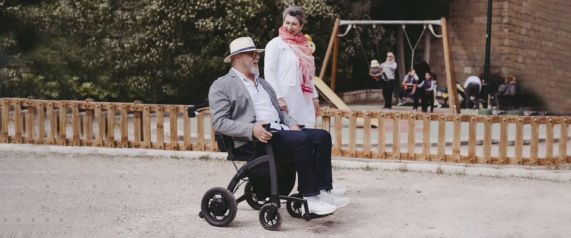 Man walking with the Rollz Motion Electric wheelchair in a parc