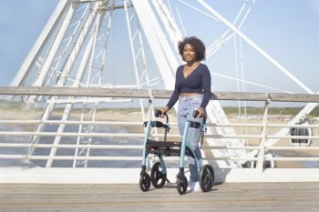 Woman walking with a Rollz Motion rollator with seat at a beach