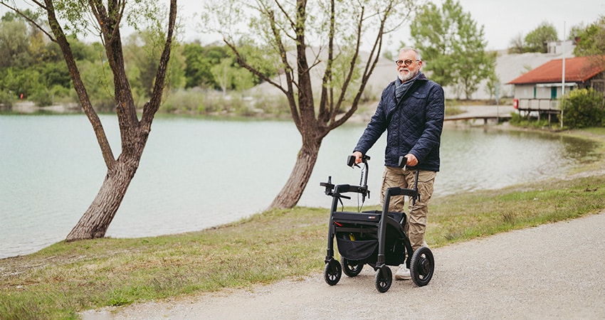 Man walking with a rollator for fall prevention
